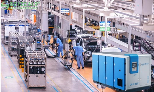 Air compressor powering pneumatic tools in automotive production