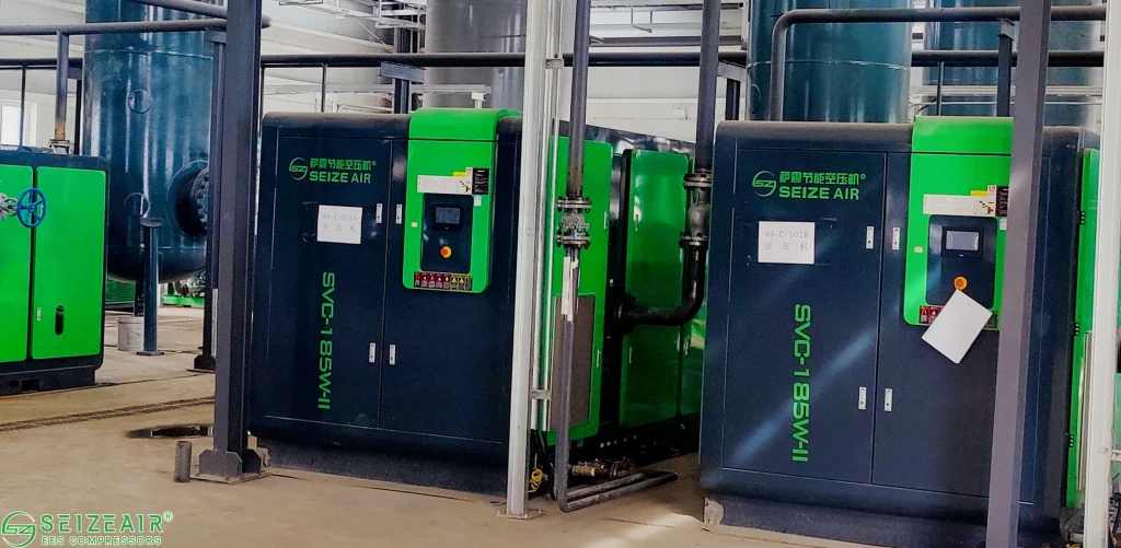 Oil-injected screw air compressor operating in a manufacturing plant