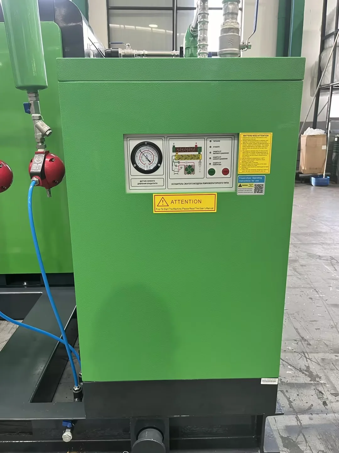 Green air dryer cabinet with its control panel and connected pipework